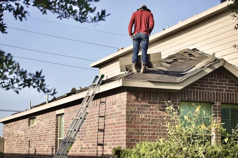 Professional roofer working on a residential roof in Jefferson Oaks